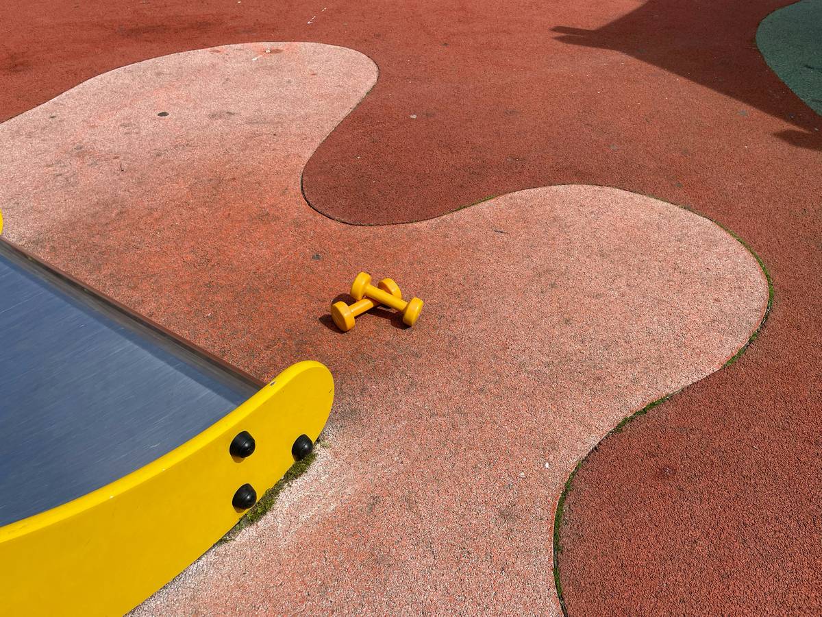 playground soft surface tiles design showing interlocked EPDM tiles with tapered edges, installed on properly graded base with visible drainage grooves